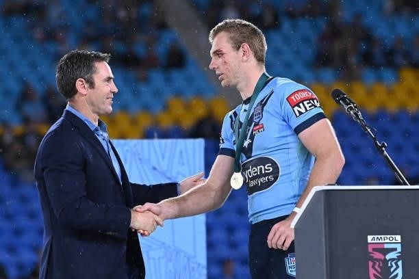 Tom Trbojevic of the Blues receives the Man of the Series awards from Blues coach Brad Fittler during the trophy presentation after game three of the...