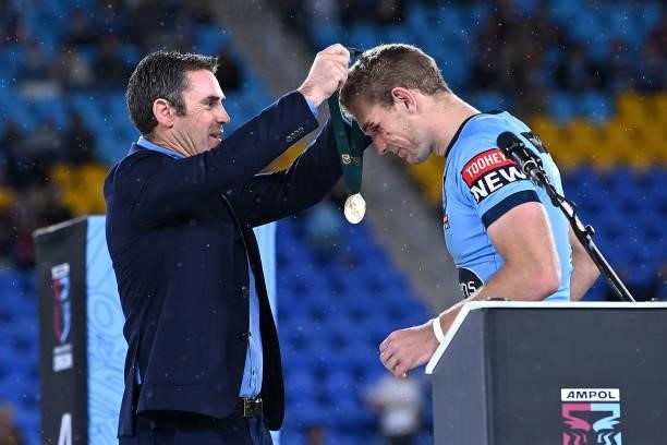 Tom Trbojevic of the Blues receives the Man of the Series awards from Blues coach Brad Fittler during the trophy presentation after game three of the...