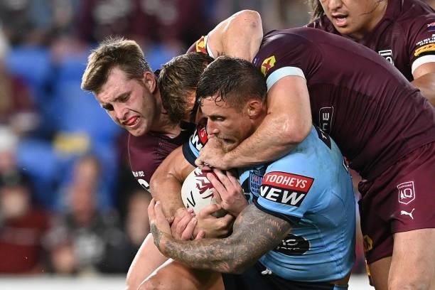 Tariq Sims of the Blues is tackled during game three of the 2021 State of Origin Series between the New South Wales Blues and the Queensland Maroons...