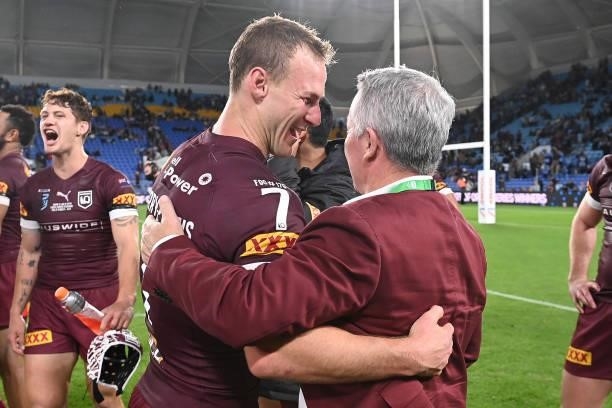 Daly Cherry-Evans of the Maroons and Maroons coach Paul Green celebrate winning game three of the 2021 State of Origin Series between the New South...