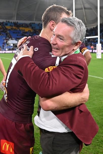 Daly Cherry-Evans of the Maroons and Maroons coach Paul Green celebrate winning game three of the 2021 State of Origin Series between the New South...