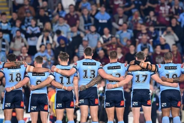 The Blues stand and sing the national anthem before game three of the 2021 State of Origin Series between the New South Wales Blues and the...