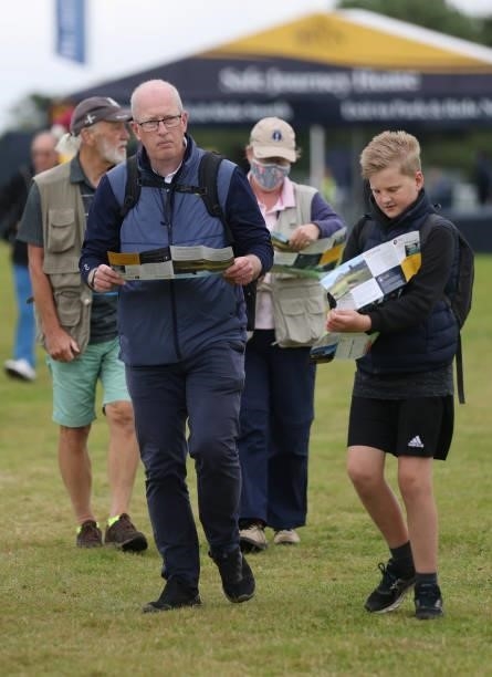 Spectators observe maps upon arriving to course during a practice round for The 149th Open at Royal St George’s Golf Club on July 14, 2021 in...