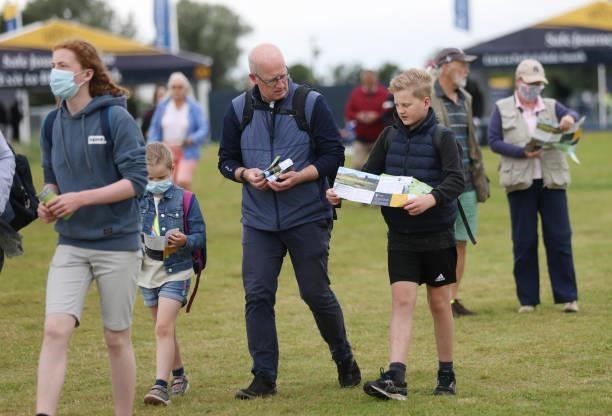 Spectators observe maps upon arriving to course during a practice round for The 149th Open at Royal St George’s Golf Club on July 14, 2021 in...