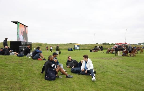 Spectators enjoy a drink during a practice round for The 149th Open at Royal St George’s Golf Club on July 14, 2021 in Sandwich, England.