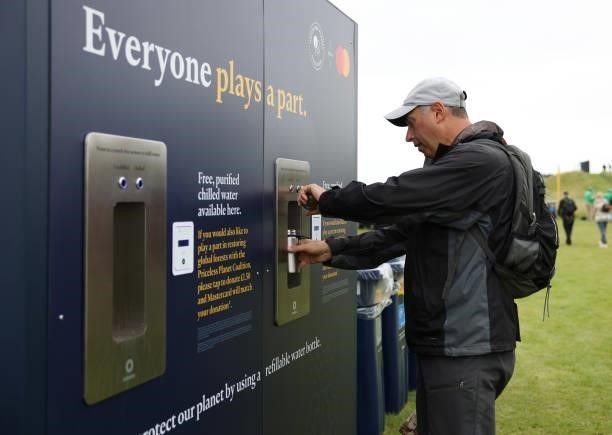 Spectator fills up a reusable water bottle during a practice round for The 149th Open at Royal St George’s Golf Club on July 14, 2021 in Sandwich,...
