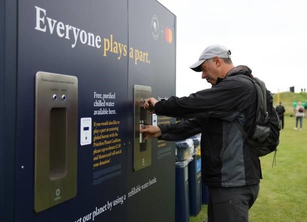 Spectator fills up a reusable water bottle during a practice round for The 149th Open at Royal St George’s Golf Club on July 14, 2021 in Sandwich,...