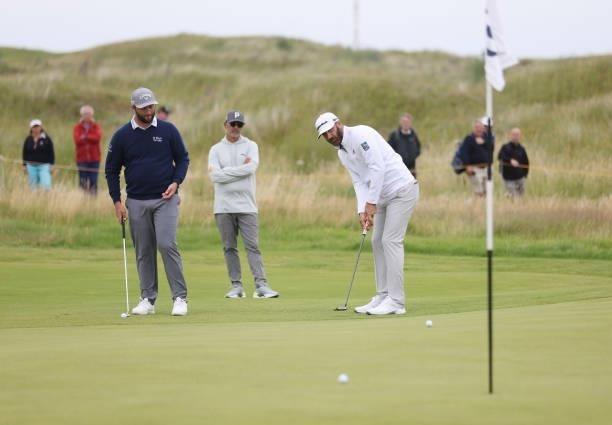 Dustin Johnson of The United States and Jon Rahm of Spain putt during a practice round for The 149th Open at Royal St George’s Golf Club on July 14,...