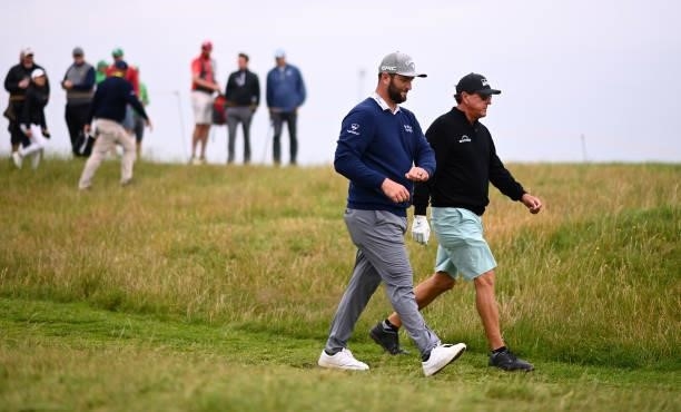 Jon Rahm of Spain and Phil Mickelson of the United States walk on the 17th hole during a practice round for The 149th Open at Royal St George’s Golf...