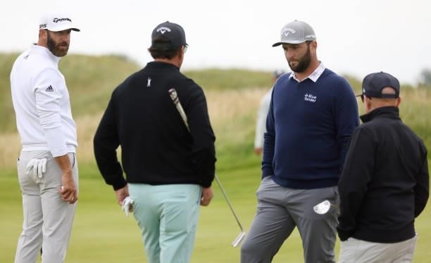 Dustin Johnson, Phil Mickelson of the United States and Jon Rahm of Spain talk during a practice round for The 149th Open at Royal St George’s Golf...