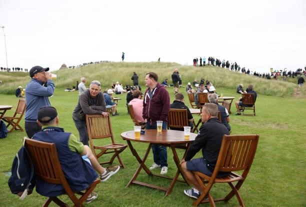 Spectators enjoy a drink during a practice round for The 149th Open at Royal St George’s Golf Club on July 14, 2021 in Sandwich, England.