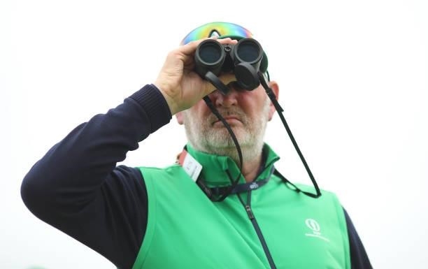 Marshal looks through binoculars during a practice round for The 149th Open at Royal St George’s Golf Club on July 14, 2021 in Sandwich, England.