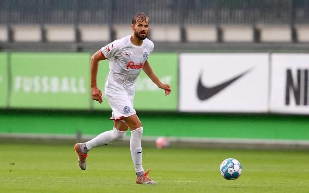 Stefan Thesker of Holstein Kiel runs with the ball during a pre-season friendly match between VfL Wolfsburg and Holstein Kiel at AOK-Stadion on July...