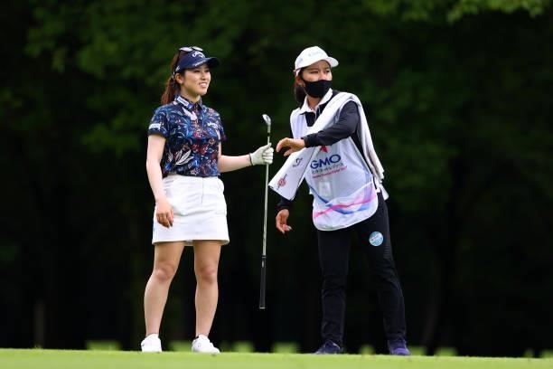 Yuna Nishimura of Japan talks with her caddie Riri Sadoyama during the pro-am ahead of the GMO Internet Ladies Samantha Thavasa Global Cup at Eagle...