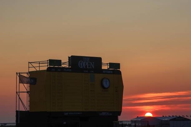 The sun rises over the scoreboard on the eighteenth hole during Day One of The 149th Open at Royal St George’s Golf Club on July 15, 2021 in...