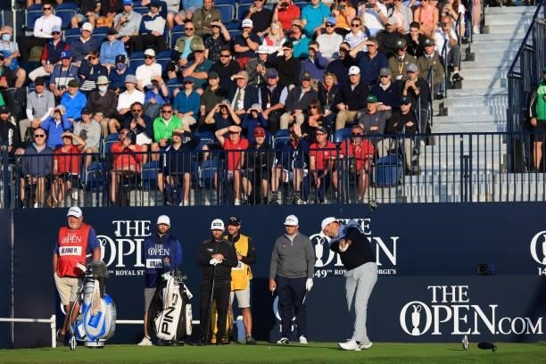 Fans watch on as Richard Bland of England plays the opening tee shot from the first hole during Day One of The 149th Open at Royal St George’s Golf...