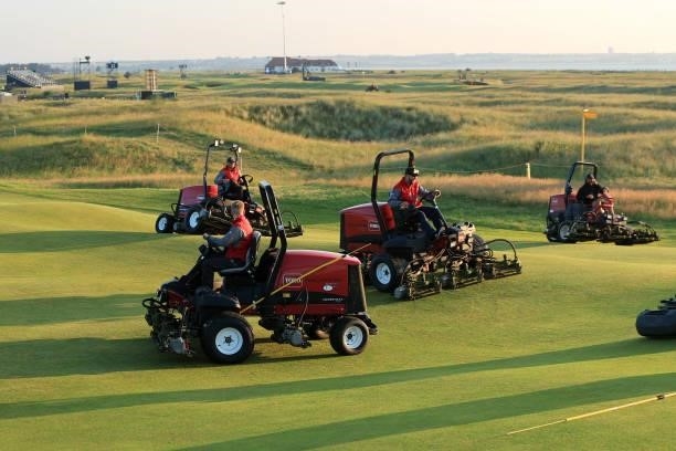 Greenkeepers drive fairway lawnmowers across the tenth hole ahead of Day One of The 149th Open at Royal St George’s Golf Club on July 15, 2021 in...