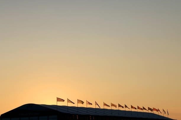 The sun rises over hospitality suites on the eighteenth hole during Day One of The 149th Open at Royal St George’s Golf Club on July 15, 2021 in...
