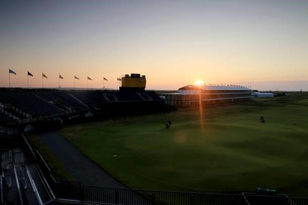 Greenkeepers work on the eighteenth hole as the sun rises ahead of Day One of The 149th Open at Royal St George’s Golf Club on July 15, 2021 in...