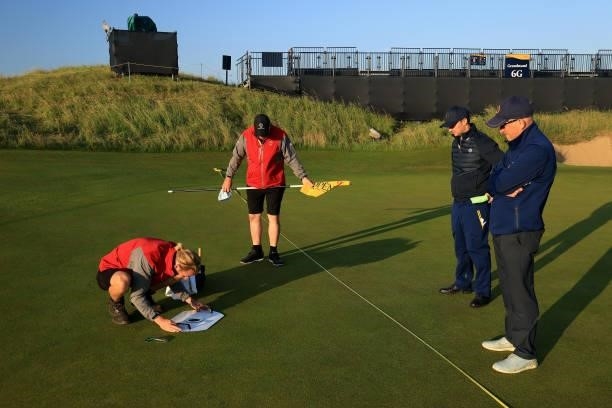 Greenkeepers tend to the course on the 6th green ahead of Day One of The 149th Open at Royal St George’s Golf Club on July 15, 2021 in Sandwich,...