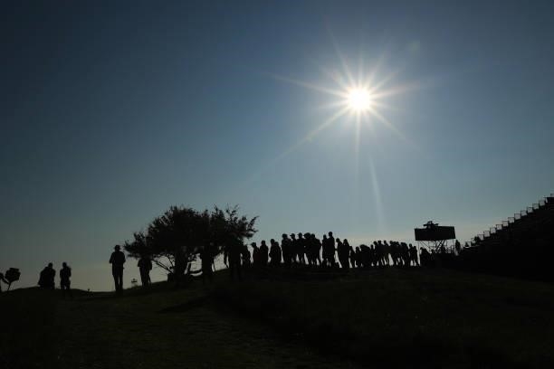 Fans are seen watching over the green of the third hole during Day One of The 149th Open at Royal St George’s Golf Club on July 15, 2021 in Sandwich,...