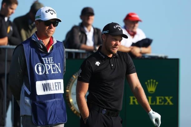 Danny Willett of England and his caddie, John Smart look on at the third tee during Day One of The 149th Open at Royal St George’s Golf Club on July...