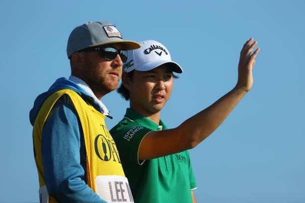 Min Woo Lee of Australia speaks with her caddie at the third tee during Day One of The 149th Open at Royal St George’s Golf Club on July 15, 2021 in...