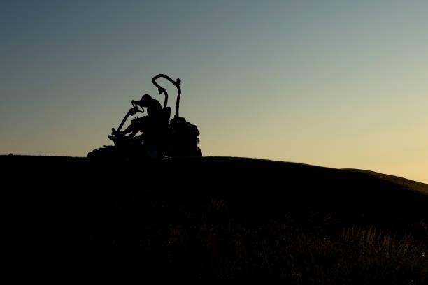 View of a greenkeeper driving a fairway lawnmower ahead of Day One of The 149th Open at Royal St George’s Golf Club on July 15, 2021 in Sandwich,...