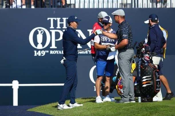 Jordan Spieth of the United States interacts with Bryson DeChambeau of the United States at the first tee during Day One of The 149th Open at Royal...