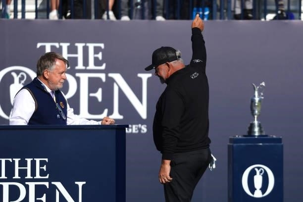 Darren Clarke of Northern Ireland acknowledges the crowd as he prepares to tee off on the 1st hole during Day One of The 149th Open at Royal St...