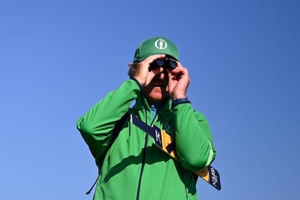 Marshal looks through binoculars during Day One of The 149th Open at Royal St George’s Golf Club on July 15, 2021 in Sandwich, England.
