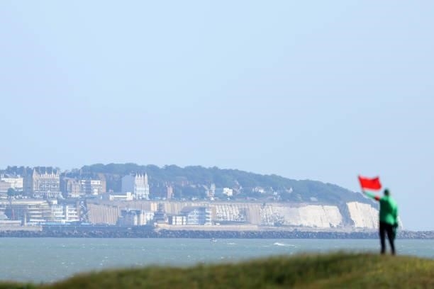 Marshal waves a flag as Ramsgate is seen on the coast during Day One of The 149th Open at Royal St George’s Golf Club on July 15, 2021 in Sandwich,...