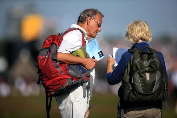 Spectators read official programmes during Day One of The 149th Open at Royal St George’s Golf Club on July 15, 2021 in Sandwich, England.