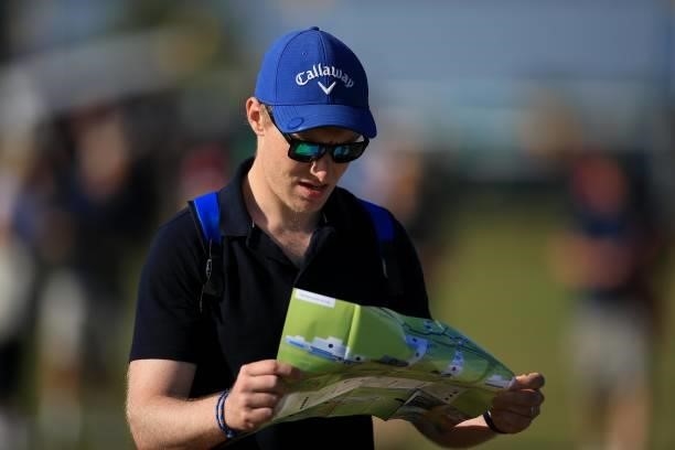 Spectator studies a course map during Day One of The 149th Open at Royal St George’s Golf Club on July 15, 2021 in Sandwich, England.