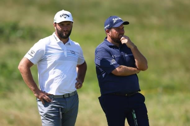 Jon Rahm of Spain and Shane Lowry of Ireland look on during Day One of The 149th Open at Royal St George’s Golf Club on July 15, 2021 in Sandwich,...
