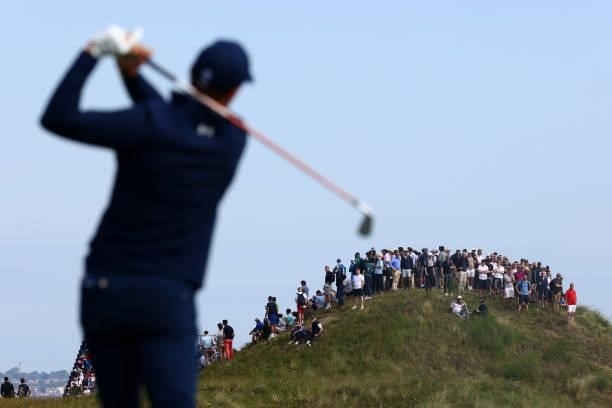 Spectators watch as Jordan Speith of United States tees off on the 5th hole during Day One of The 149th Open at Royal St George’s Golf Club on July...