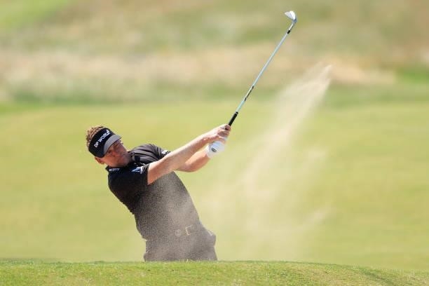 Ian Poulter of England plays out of a bunker on the 13th hole during Day One of The 149th Open at Royal St George’s Golf Club on July 15, 2021 in...