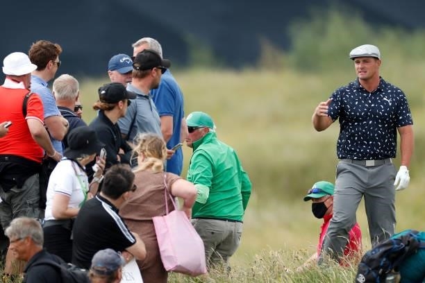 Bryson DeChambeau of the United States asks fans to move on the ninth hole during Day One of The 149th Open at Royal St George’s Golf Club on July...