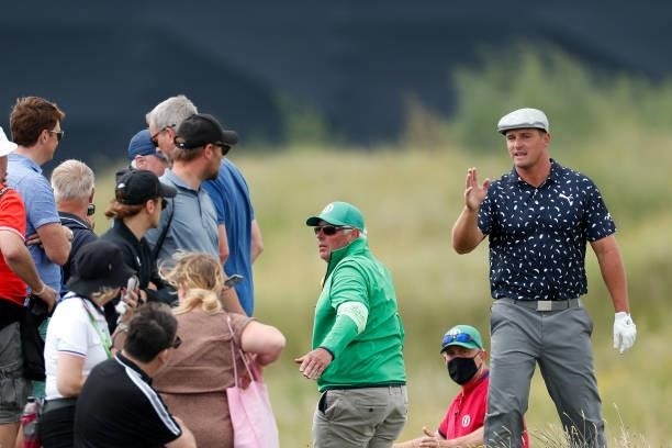 Bryson DeChambeau of the United States asks fans to move on the ninth hole during Day One of The 149th Open at Royal St George’s Golf Club on July...