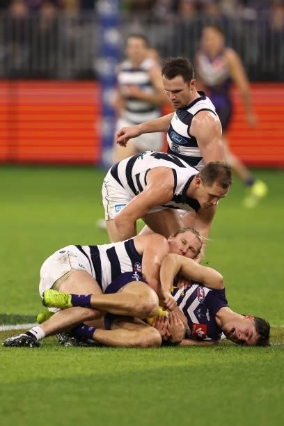 Adam Cerra of the Dockers gets tackled by Mark Blicavs of the Cats during the round 18 AFL match between the Fremantle Dockers and Geelong Cats at...