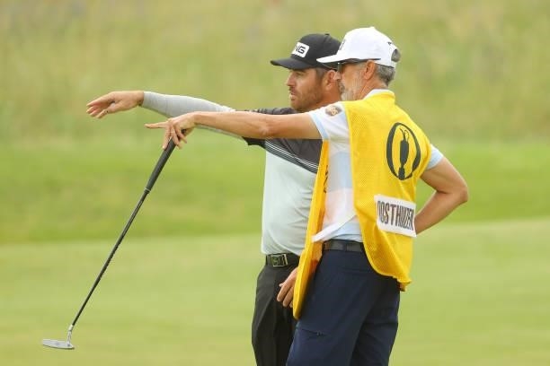 Louis Oosthuizen of South Africa reacts with his caddie, Colin Byrne on the seventh hole during Day One of The 149th Open at Royal St George’s Golf...