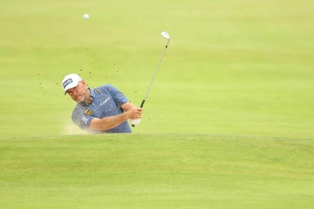 Lee Westwood of England plays a bunker shot on the seventh hole during Day One of The 149th Open at Royal St George’s Golf Club on July 15, 2021 in...