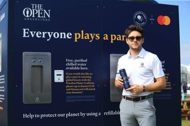 Niall Horan poses for a photograph with a reusable water bottle as he is interviewed on event sustainability during Day One of The 149th Open at...