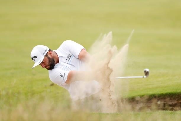 Jon Rahm of Spain plays a bunker shot during on the ninth hole on Day One of The 149th Open at Royal St George’s Golf Club on July 15, 2021 in...