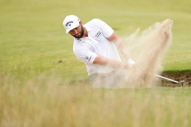 Jon Rahm of Spain plays a bunker shot during on the ninth hole on Day One of The 149th Open at Royal St George’s Golf Club on July 15, 2021 in...