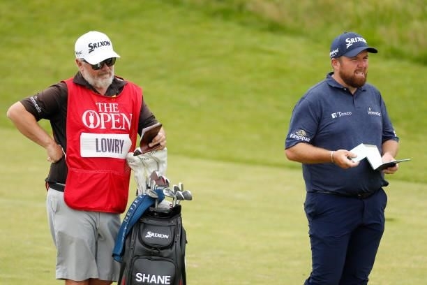 Shane Lowry of Ireland looks on with his caddie from the ne during Day One of The 149th Open at Royal St George’s Golf Club on July 15, 2021 in...