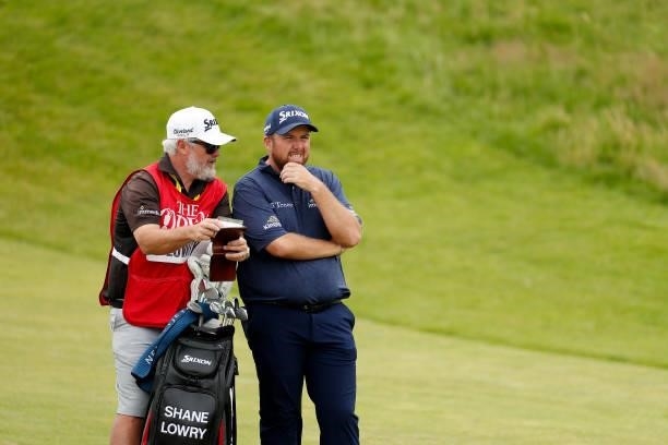 Shane Lowry of Ireland looks on with his caddie from the ninth hole during Day One of The 149th Open at Royal St George’s Golf Club on July 15, 2021...