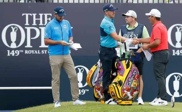 Matt Wallace of England shakes hands with Francesco Molinari of Italy on the first tee as Marc Leishman of Australia looks on during Day One of The...