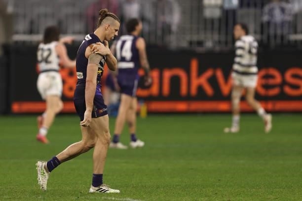 Nat Fyfe of the Dockers holds his injured shoulder during the round 18 AFL match between the Fremantle Dockers and Geelong Cats at Optus Stadium on...