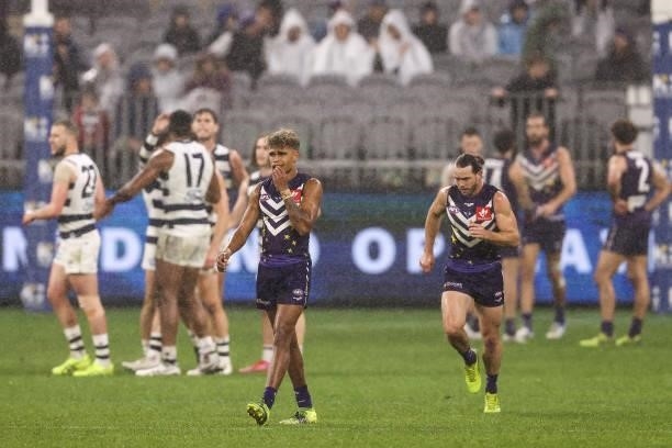 Liam Henry of the Dockers looks on as Geelong celebrate a goal during the round 18 AFL match between the Fremantle Dockers and Geelong Cats at Optus...